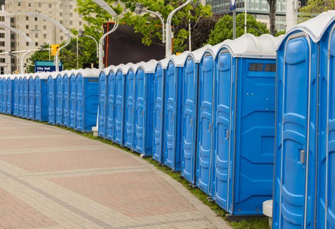 a row of portable restrooms set up for a large athletic event, allowing participants and spectators to easily take care of their needs in Linden, CA